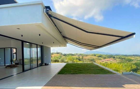 Toldo de brazos extensibles abierto sobre una terraza